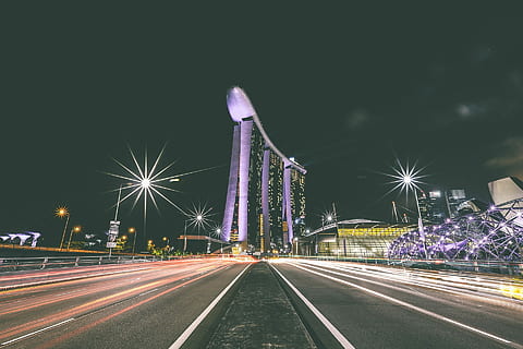 time lapse photography at center island of highway next to Marina Bay Sands during night time HD wallpaper