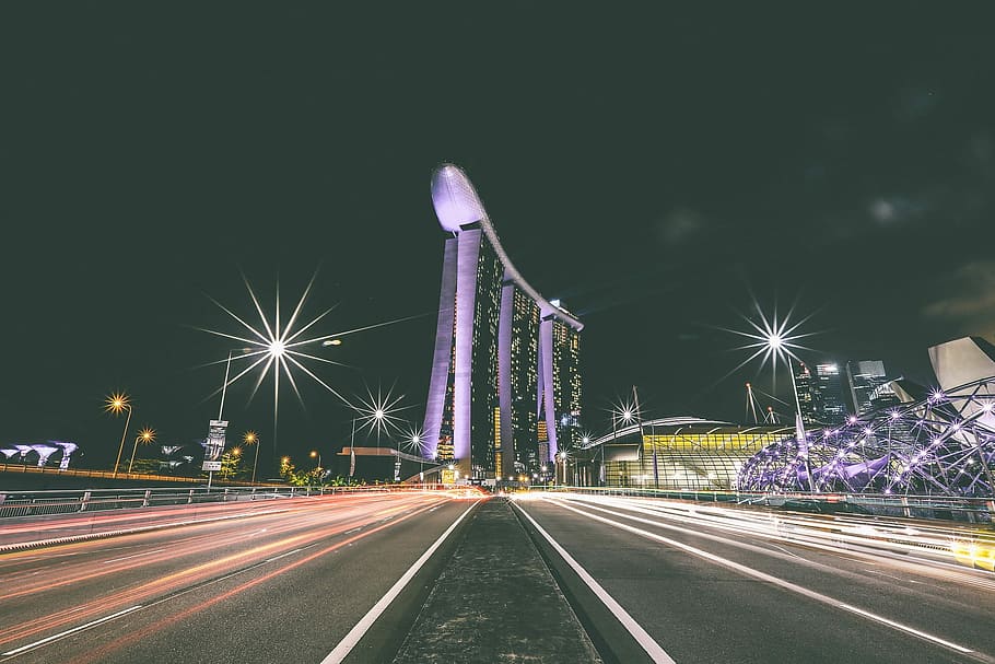 time lapse photography at center island of highway next to Marina Bay Sands during night time HD wallpaper