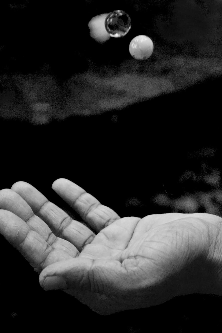 grayscale of palm with two marble toys, juggle, marbles, throw HD wallpaper