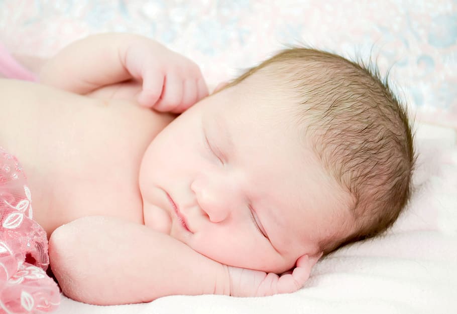 sleeping baby in close-up photography, white, fleece, blanket