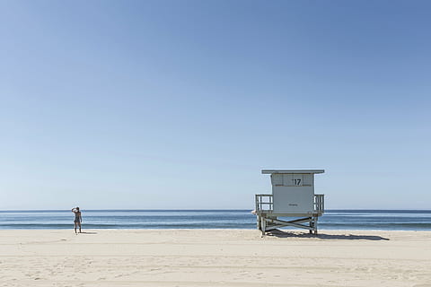 rule of thirds photography of person standing in seashore, white HD wallpaper