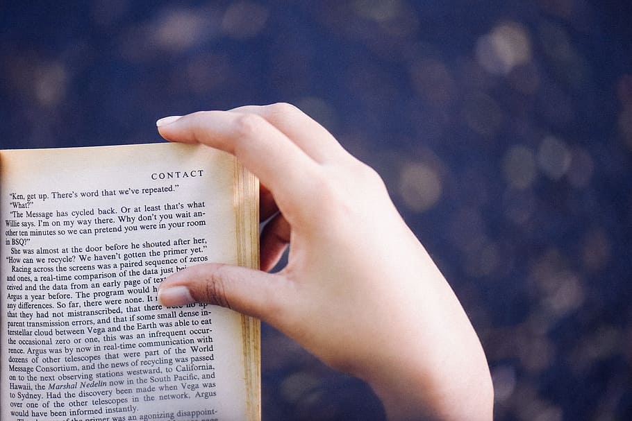 person turning book page, bokeh photography of person holding book HD wallpaper