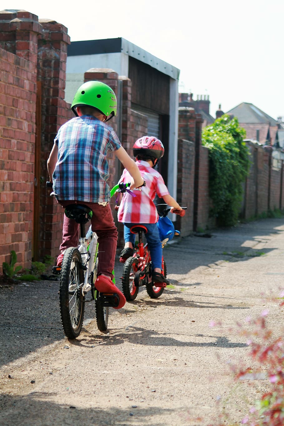 two children riding the bike, alley, bicycles, bicyclists, bikes