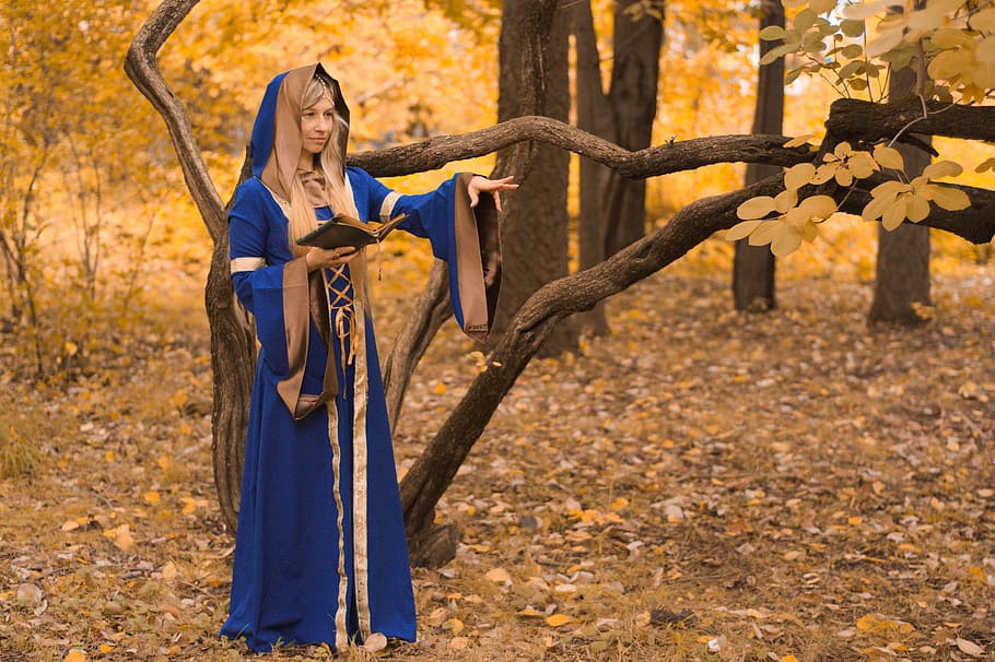 woman dressed as a wizard in the forest casting a spell, magic HD wallpaper