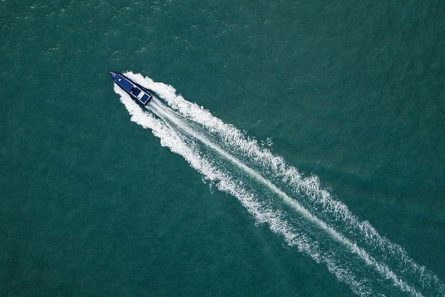 top view photography of blue boat at daytime, blue motorboat on body of water
