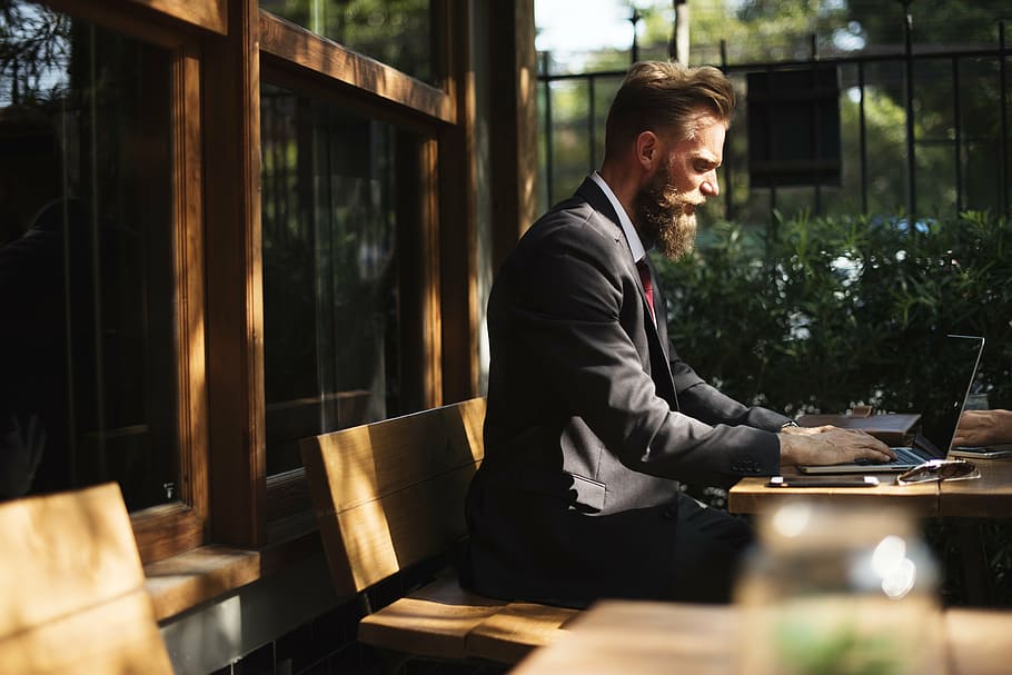 man wearing suit jacket sitting using laptop, beard, break, business