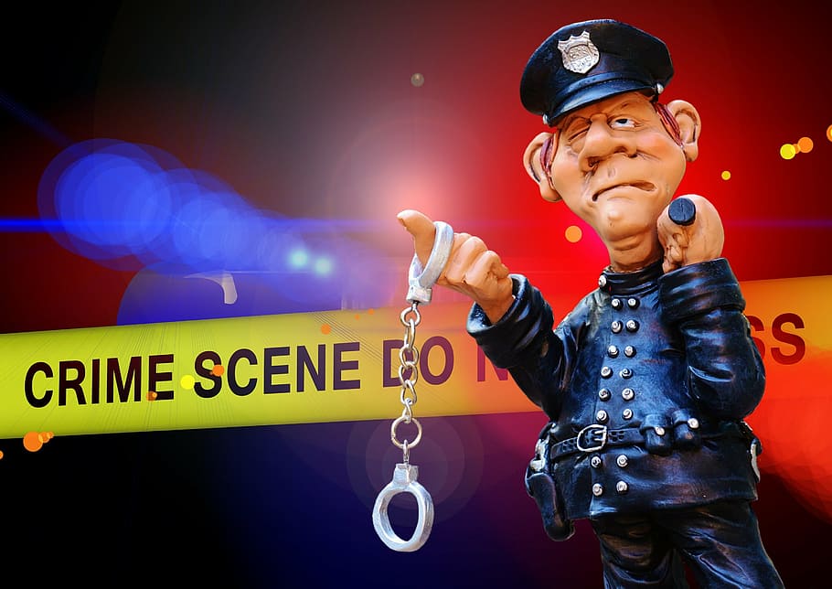 police figurine holding handcuffs, crime scene, blue light, discovery