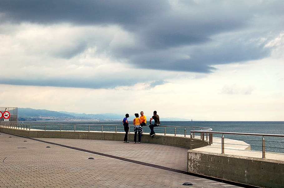 four person beside body of water, wella, hotel, people, clouds HD wallpaper