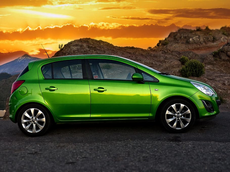 green 5-door hatchback on gray asphalted road across brown mountain during golden hour, HD wallpaper