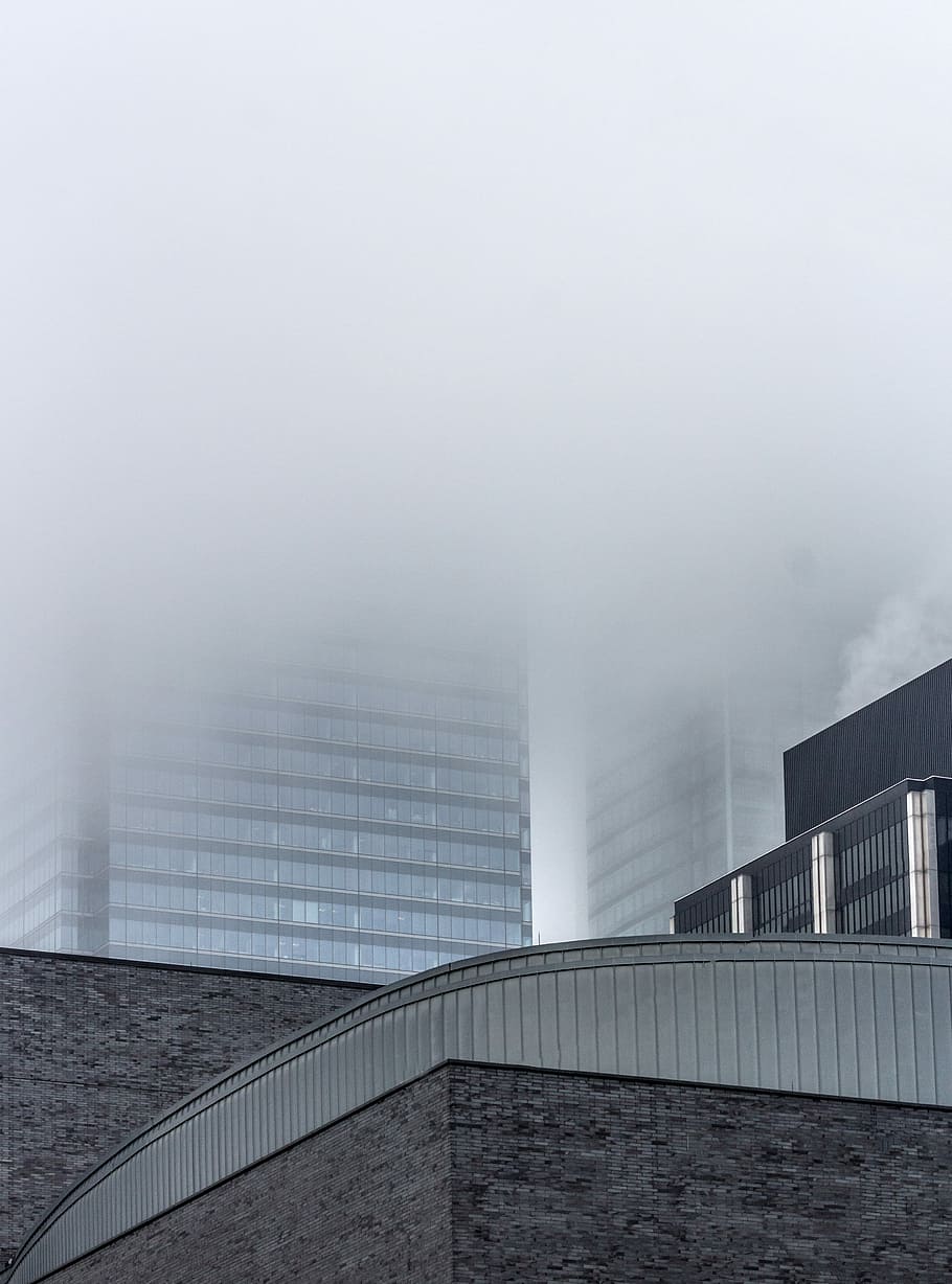 low-angle photography of building surrounded by clouds, architectural photograph of city structures HD wallpaper