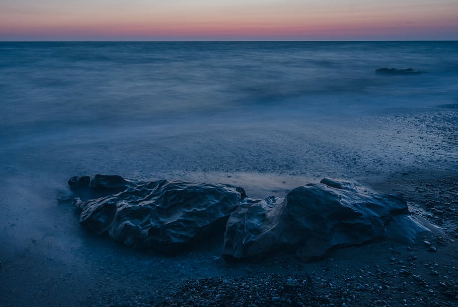 grey rock on sand, overlooking photo of stone on seashore during golden hour HD wallpaper