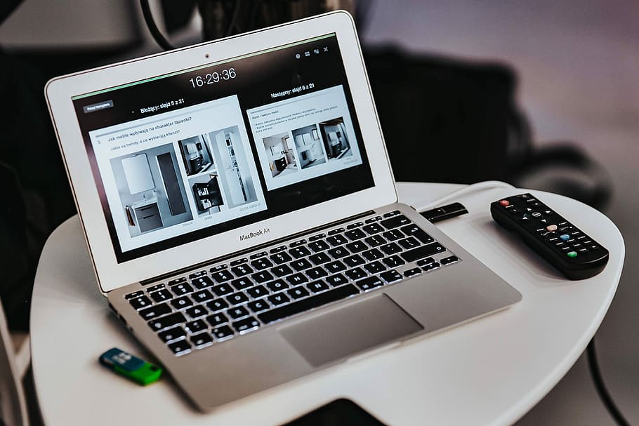 White laptop on a table with a remote, Apple, computer, macbook HD wallpaper