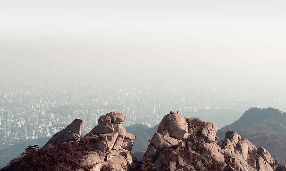 bird's eye photography of mountain, closeup photo of brown rocks near mountain HD wallpaper