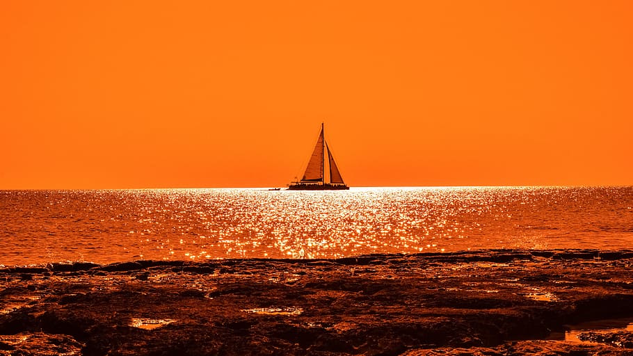 boat on body of water, sunset, sunlight, catamaran, rocky coast HD wallpaper