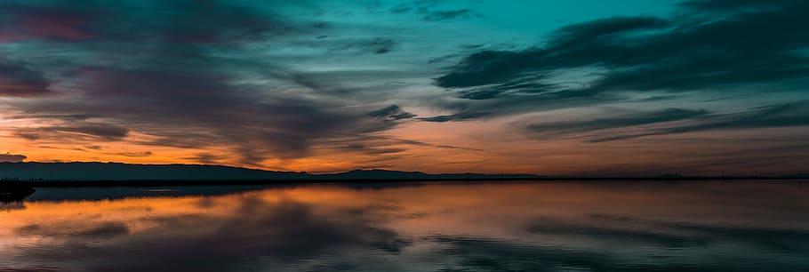 body of water under cloudy sky, landscape photography of mountain HD wallpaper