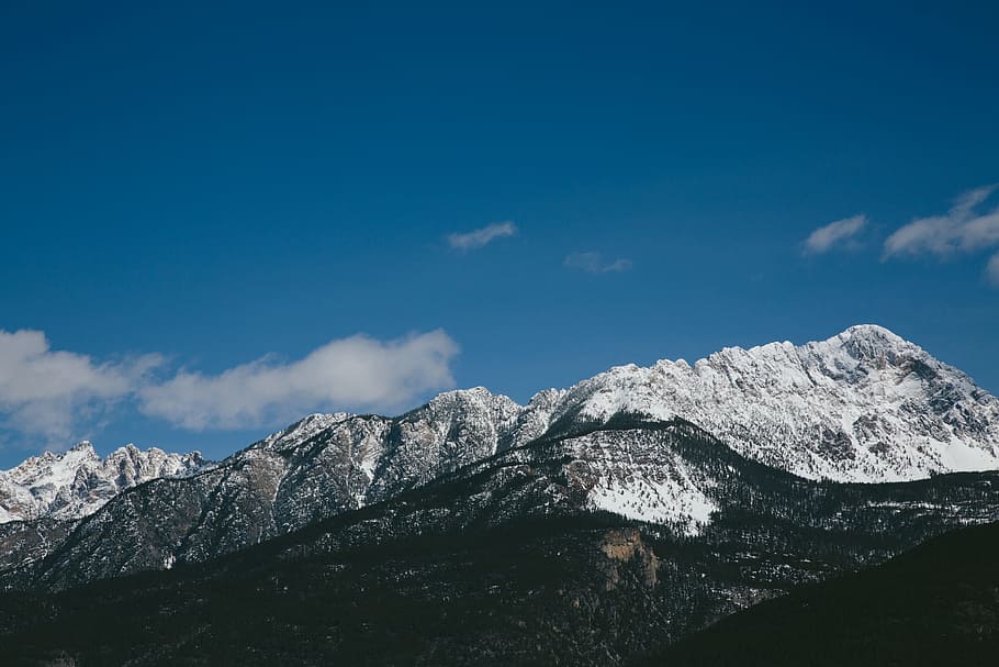 mountain ranges under white clouds during daytime, gray and black mountain under blue sky during daytime HD wallpaper