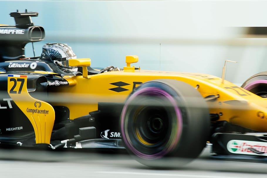 sports photography of yellow and black F1 race car, man driving a yellow F1 car HD wallpaper