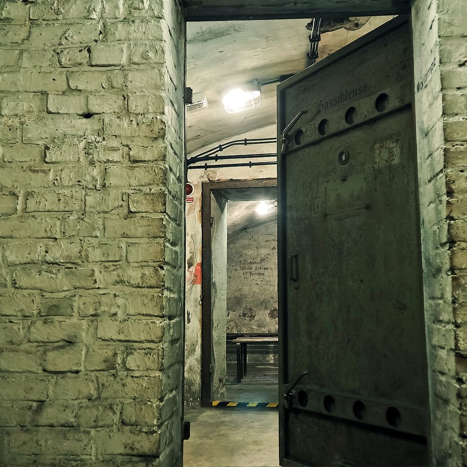 black metal door half open with lights turned-on inside, Bunker