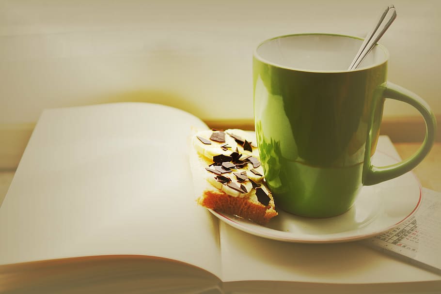 green and white ceramic mug place on saucer and book, cup, breakfast