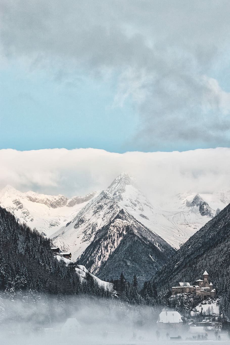 aerial view photography of mountains under cloudy sky, gray mountain filled with snow during daytime HD wallpaper