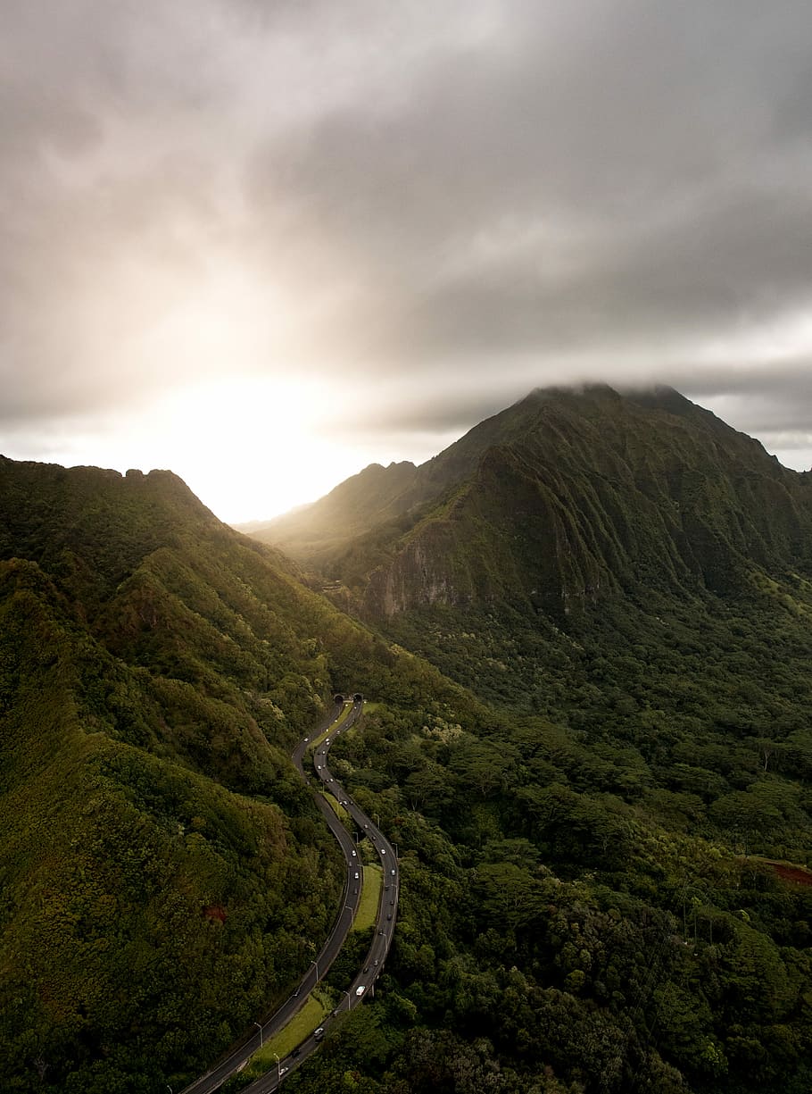 green mountain during cloudy day, aerial photography of green mountain under grey clouds HD wallpaper
