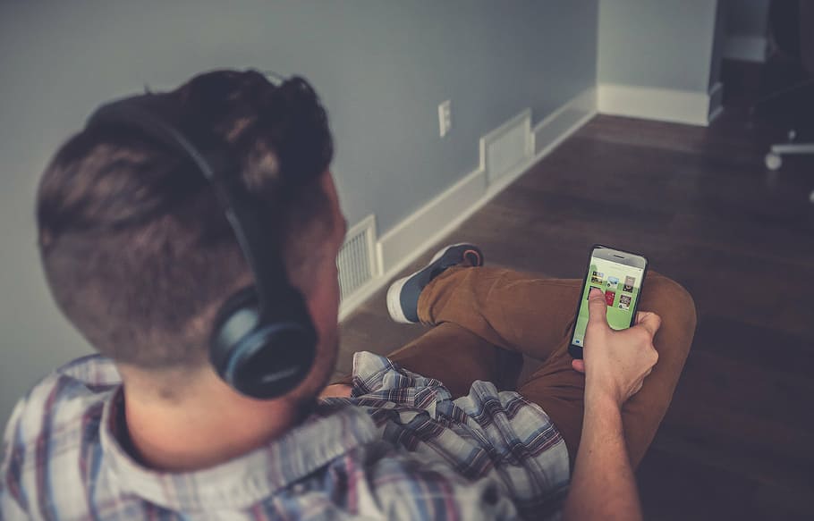 man holding a smartphone while using a headphones, mobile, inside HD wallpaper