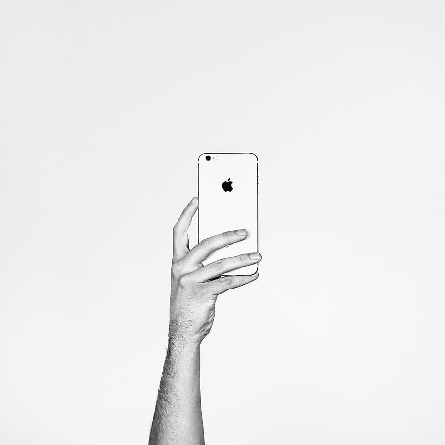 grayscale photography of person holding iPhone, mobile, apple