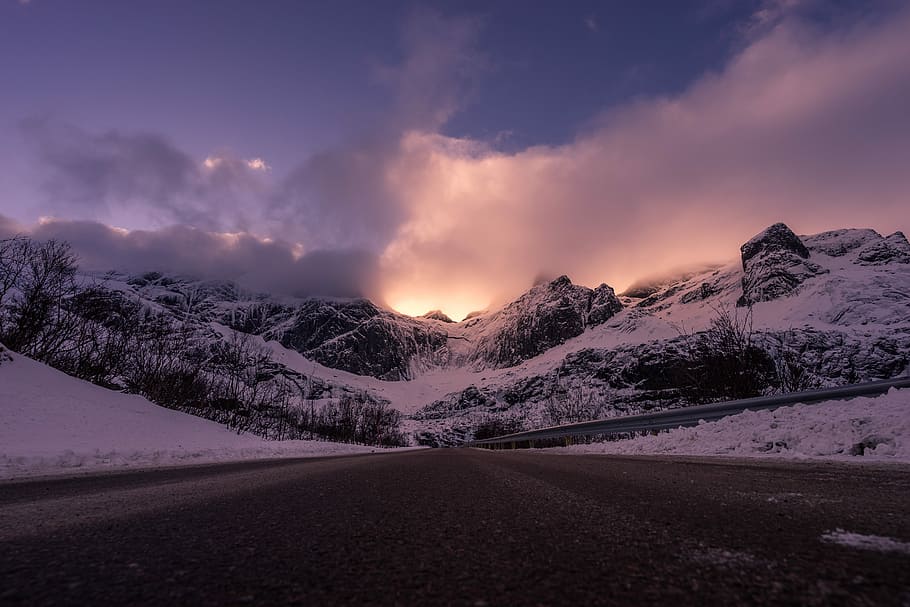 photo of snow mountains during sunset, concrete road near snow covered mountain HD wallpaper