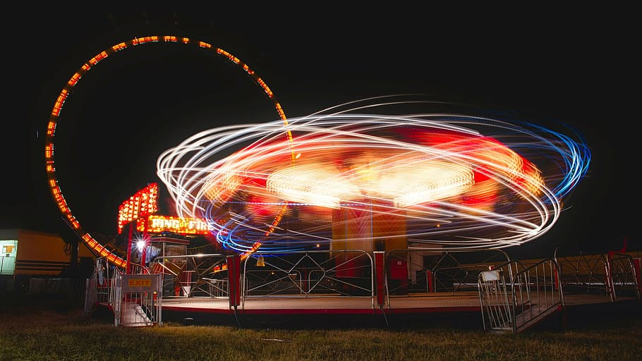 time lapse photography of amusement park, county fair, ride, tilt a whirl