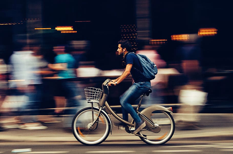 Man Riding Bicycle on City Street, action, adult, athletes, bike