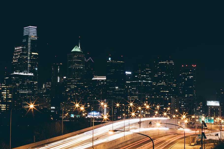 streetlights near buildings during daytime, time-lapse photography of cars with skyscraper background HD wallpaper