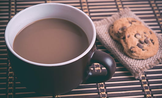black and white ceramic mug filled with coffee beside cookies HD wallpaper