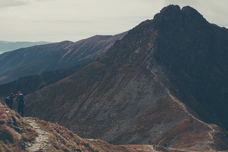 scenery of mountain, two person standing on top of mountain during daytime HD wallpaper