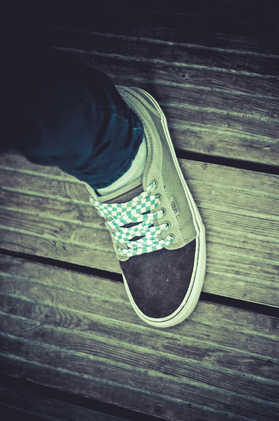 person wearing black and gray Vans skate shoe, unpaired, chukka