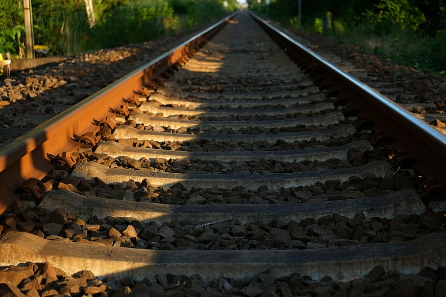 person taking photo of train tracks, railway, seemed, railroad tracks