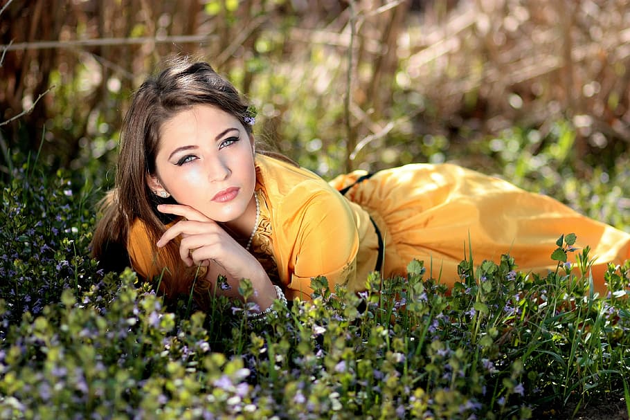 woman lying on green grass, girl, blue eyes, seductive, flowers