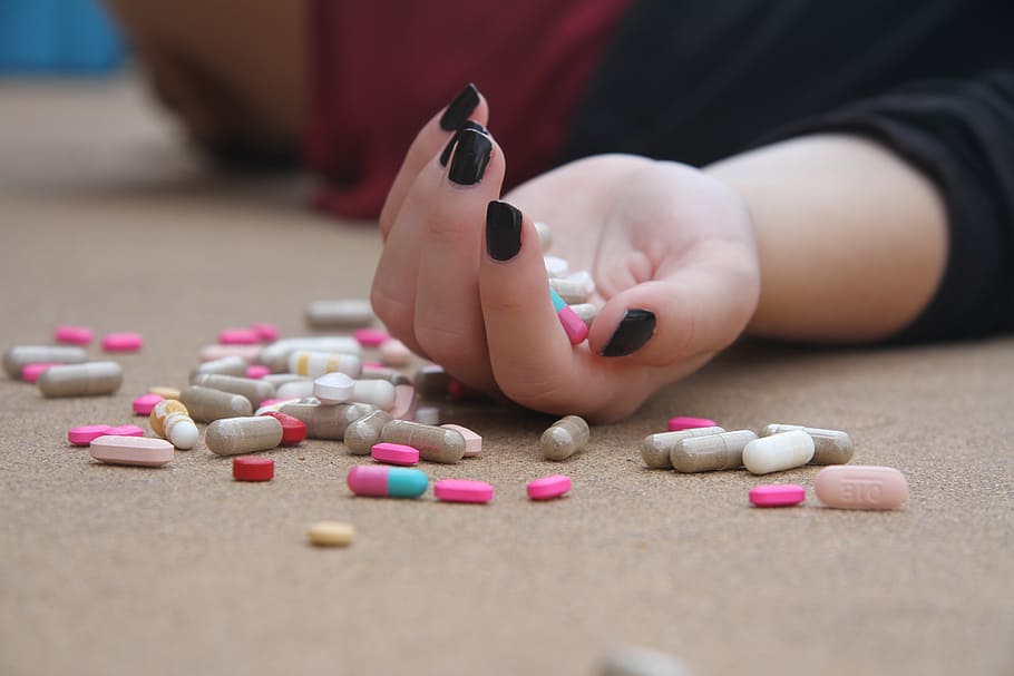 person hand holding medication pills, depression, mental health