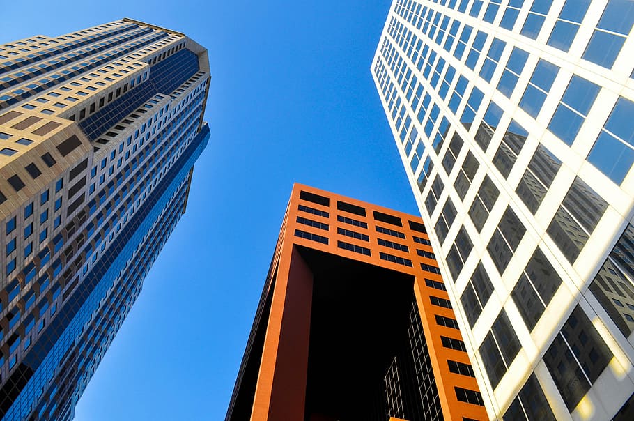 low angle photography of brown and white concrete buildings during daytime HD wallpaper