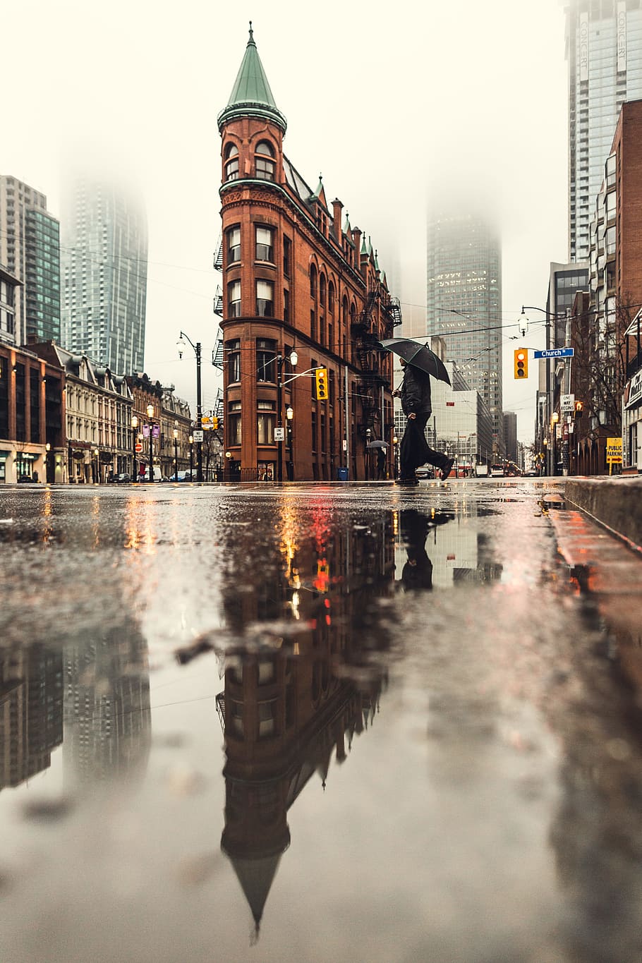 man using umbrella crossing the street during daytime, low angle photograph of brown buildng HD wallpaper