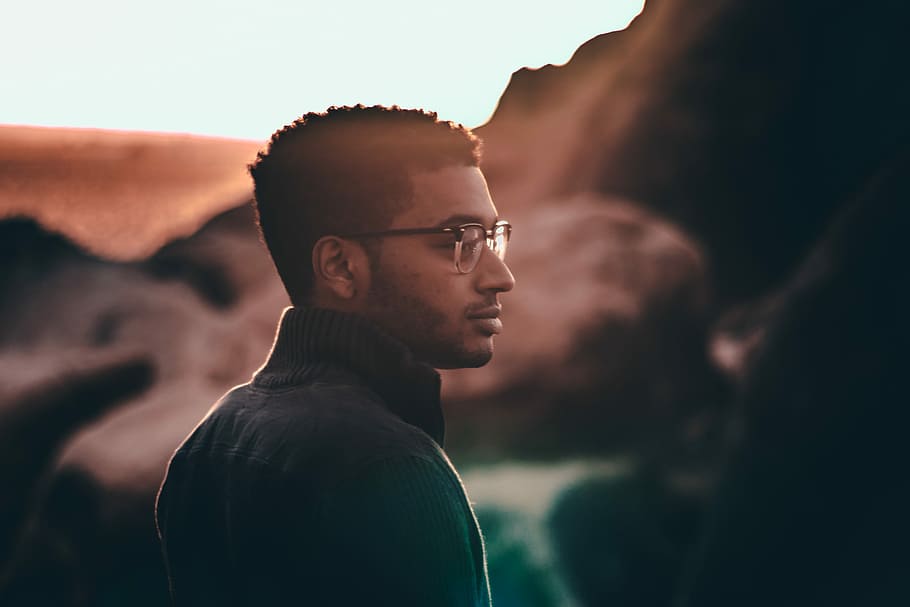 selective focus photo of man looking right side view, selective focus photography of man standing while wearing black top and eyeglasses, HD wallpaper