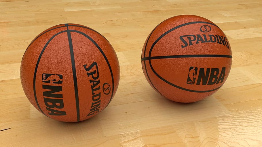 two brown Spalding NBA basketballs on wooden floor, blender, 3d