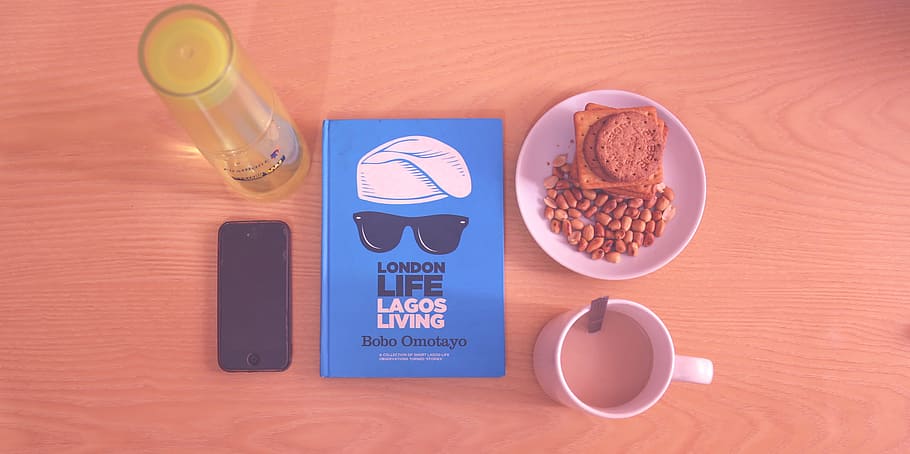 Peanuts and Biscuits in White Ceramic Plate Beside White Ceramic Mug Near Lagos Living Book HD wallpaper
