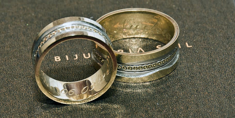 two gold-colored rings on gray surface, wedding, wedding rings