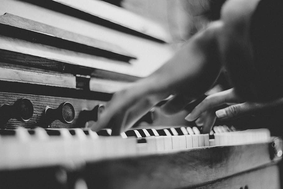 gray scale photo of person playing piano, grayscale photography of person playing piano