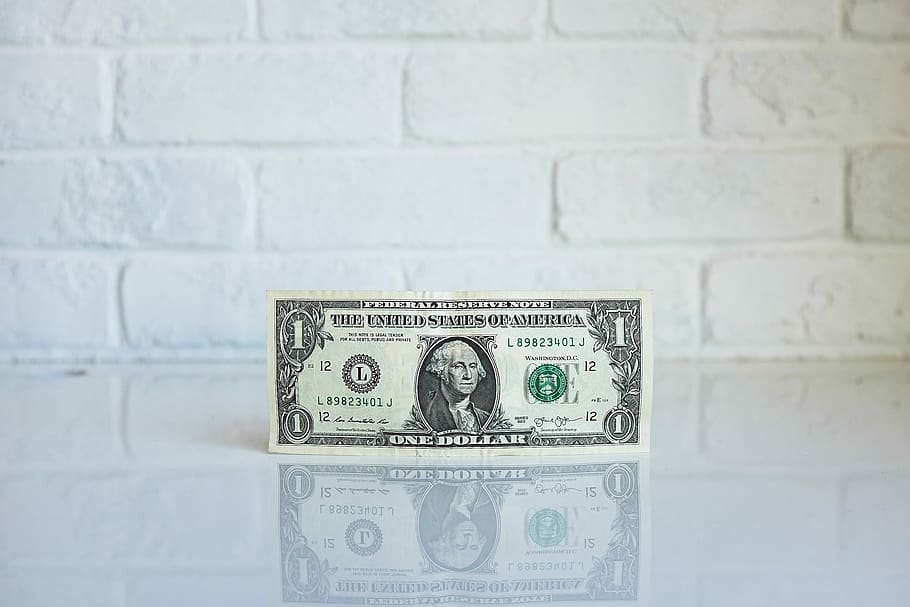 1 U.S. dollar banknote on white surface, 1 U.S. dollar banknote