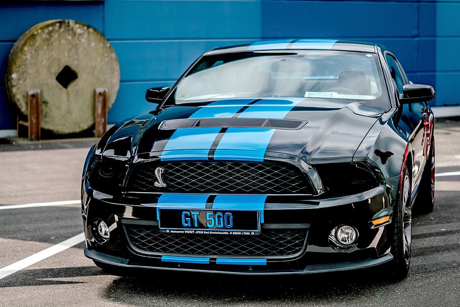 black and blue Ford Mustang GT 500 coupe on asphalt surface, auto