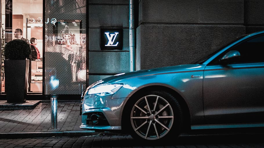 gray car parked beside Louis Vuitton store, silver car next to sidewalk