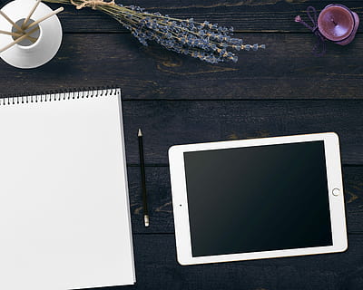 silver iPad on black surface, notepad, tablet, flowers, candle HD wallpaper