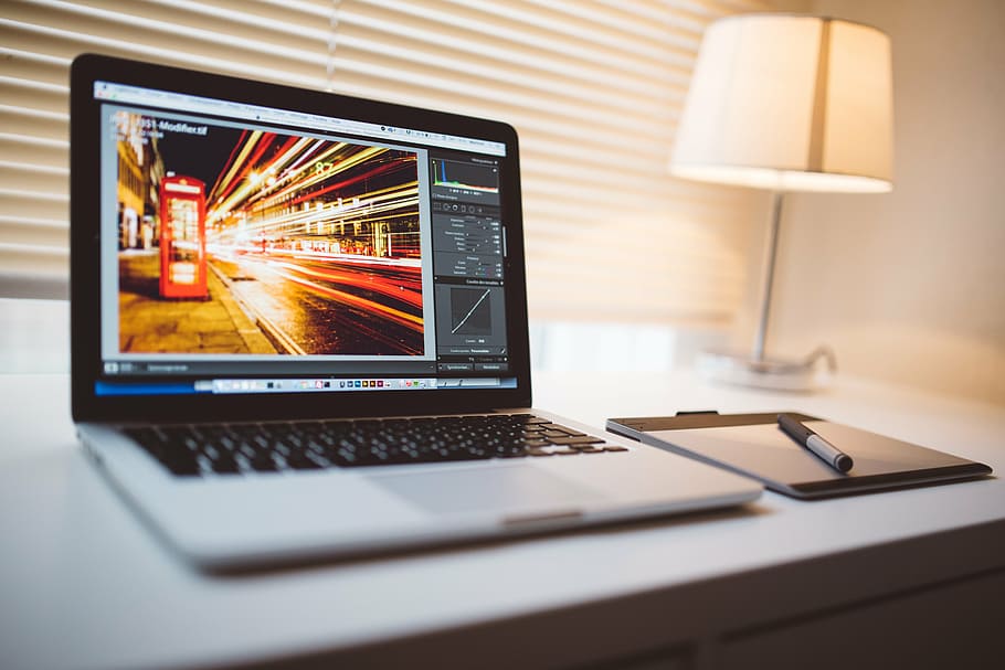 black laptop computer beside white table lamp turned on, macbook HD wallpaper