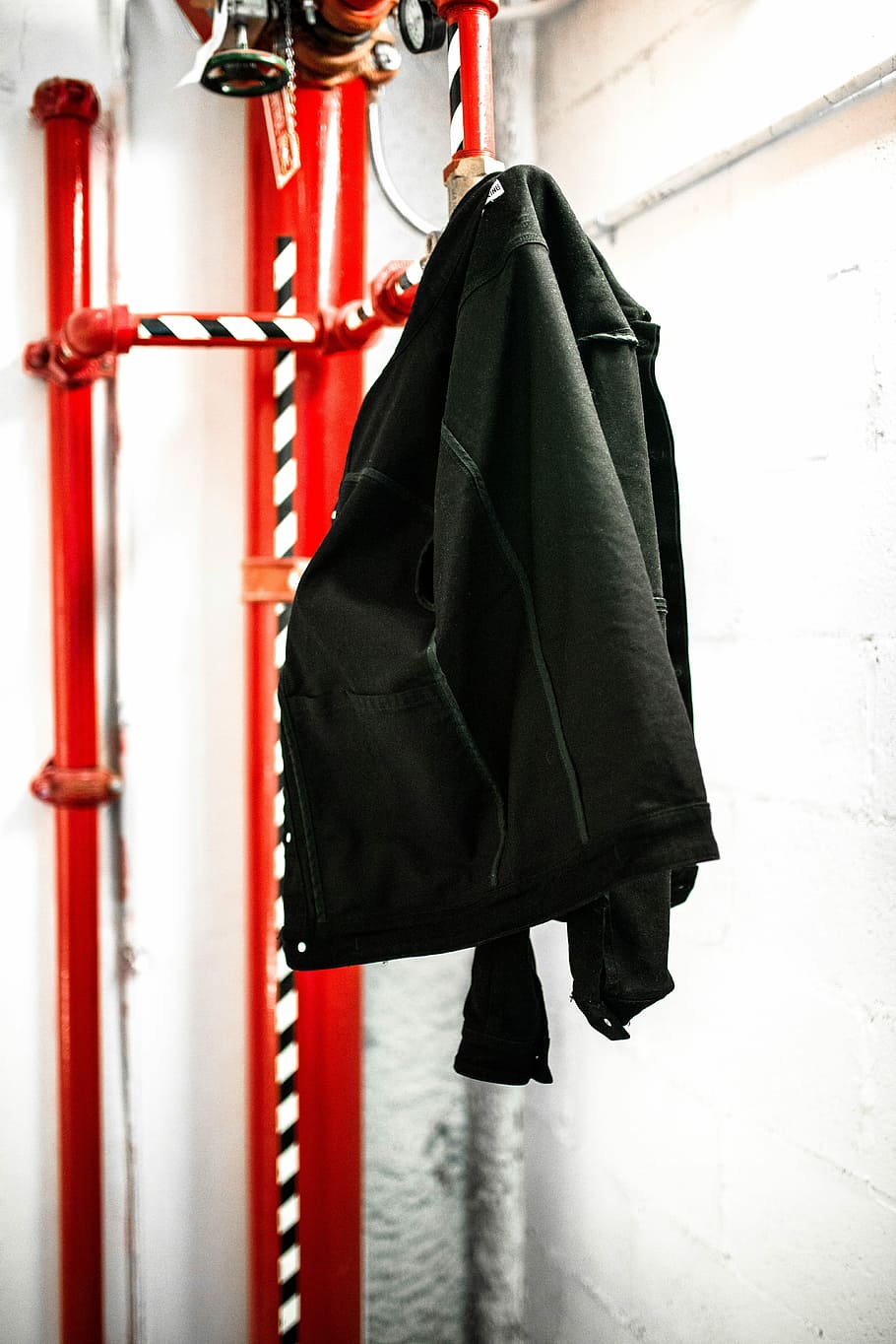 black coat hanging on red coat raack, black jacket hanging on red pipe HD wallpaper
